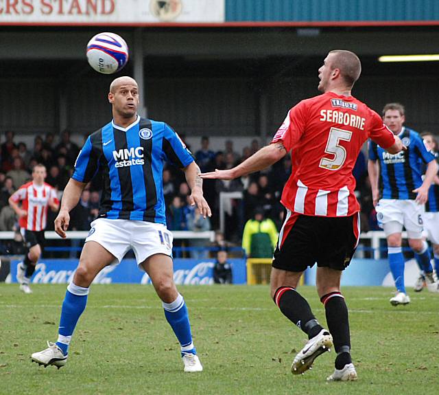 Danny Seaborne heads the ball clear.