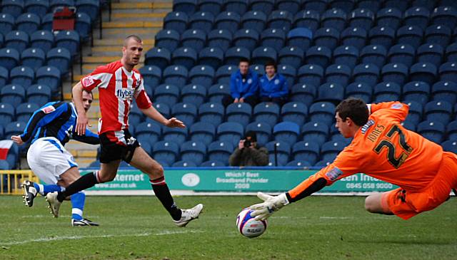 Jones saves from Dagnall.