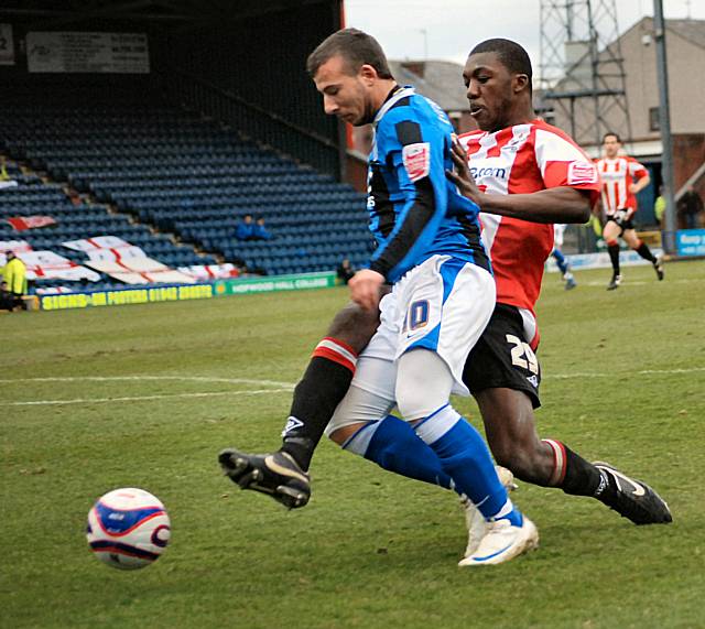 Archibald-Henville hauls down Adam Le Fondre in the box to give Rochdale their penalty.