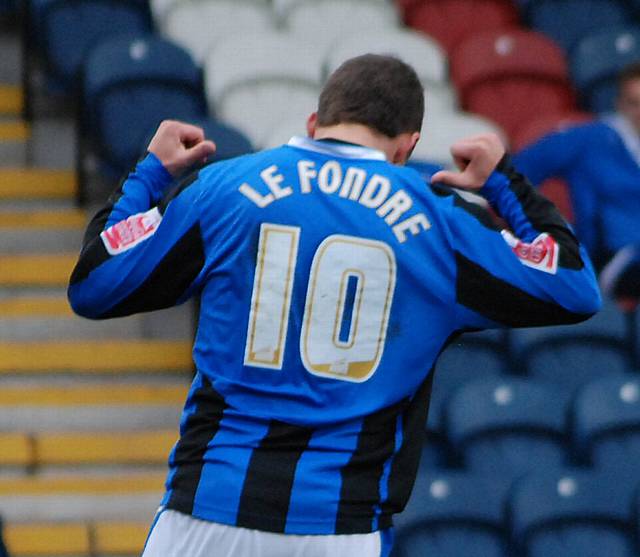 Le Fondre scores from the rebound after his penalty is saved and he wheels away to celebrate his 20th goal of the season.