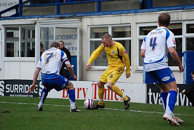 Former Bury man Nicky Adams looks to get past Stephen Dawson.