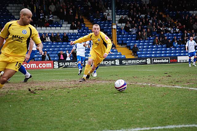 Buckley's cross narrowly evades Adams and Thorpe in the Bury box.