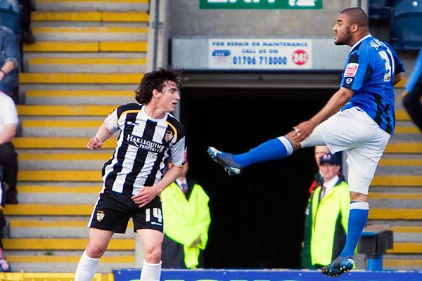 Marcus Holness clears away from Louis Dodds.