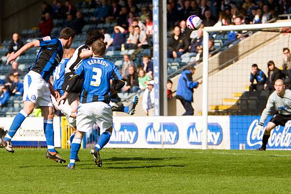 Former Rochdale striker Louis Dodds directs a header on goal.