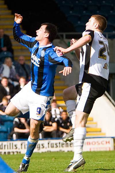 Chris Dagnall and Lee Collins challenge for a header.