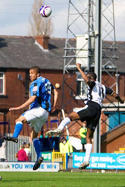 Joe Thompson and Paul Edwards go up for an aerial ball.