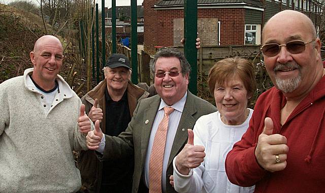 No more crossing the line: Councillors Peter Rush and Malcolm Bruce with local residents alongside the new fencing.
