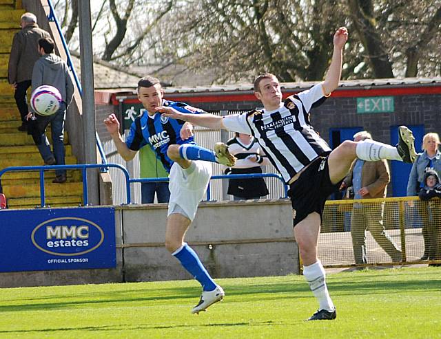 John McCombe hooks the ball clear of Ramsden.