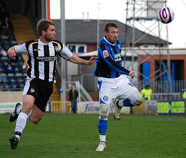 Le Fondre keeps the ball away from McCombe.