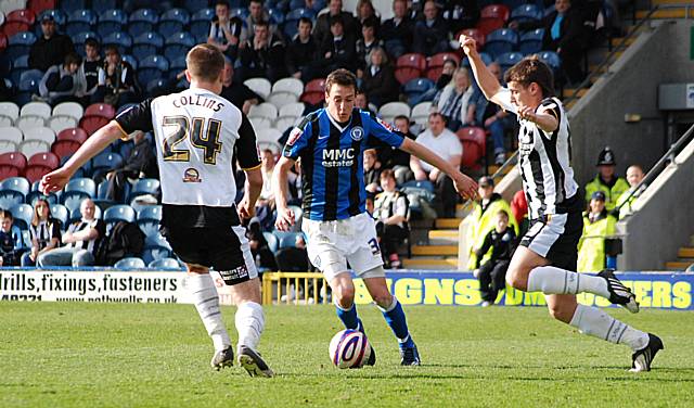 Buckley looks to get between two Dale defenders.