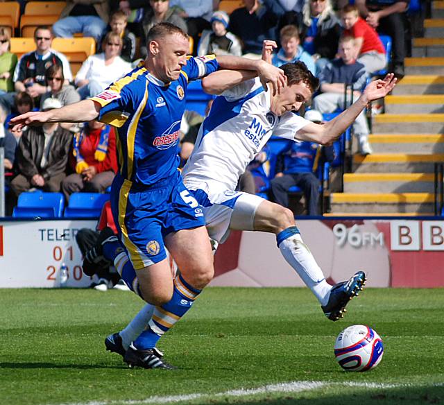 Buckley battles with Coughlan inside the Shrewsbury box.