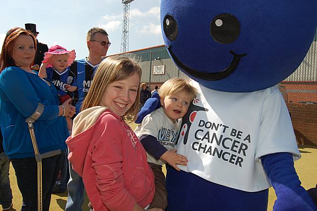 The 'cancer chancer' mascot meets young Rochdale fans during the launch event at Spotland Stadium on Saturday.