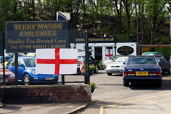 The flag of St George is being flown at Terry Mason car sales; one of many businesses celebrating St George's Day across the town.