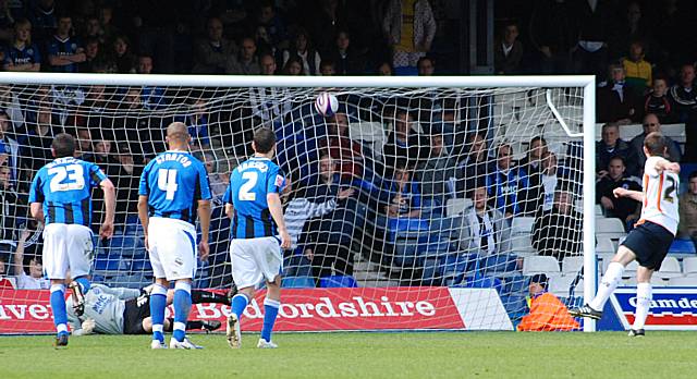 Tom Craddock rifles home Luton's penalty.