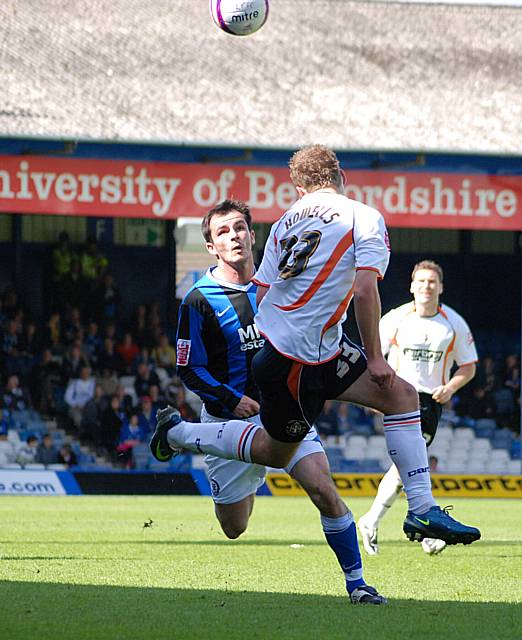 Jake Howells heads clear from Dagnall.