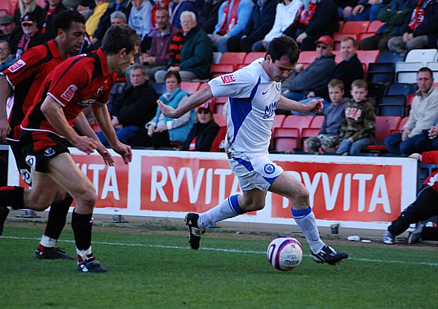 Chris Dagnall takes on two Bournemouth defenders by the touchline.