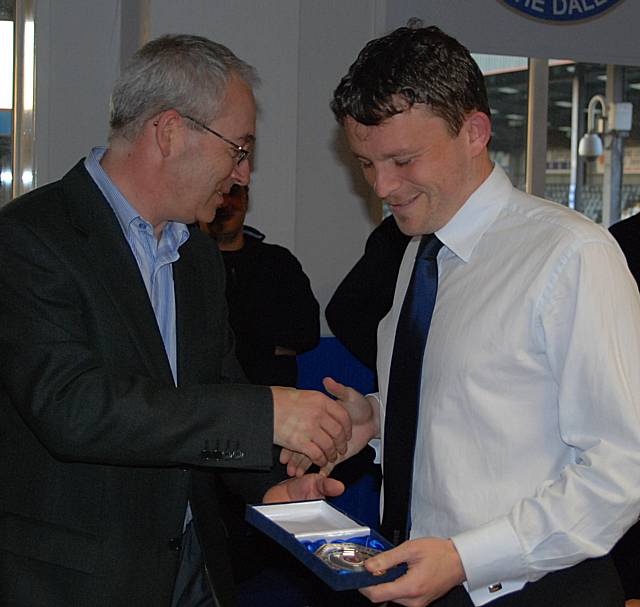 Rochdale Online director Ian Kimber presents referee Richard Wild with his medal. 