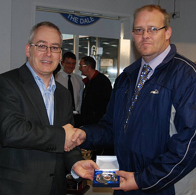 Rochdale Online director Ian Kimber presents assistant referee Nick Blackburn with his medal.