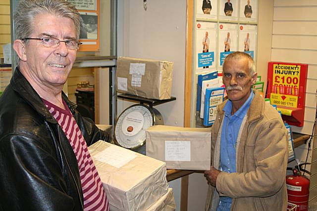 Dennis Rigg and Tony Croston weigh-in the sweets at Castleton Post Office.