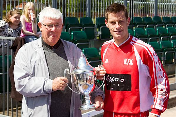 Rochdale & District Sunday Football League President Eddie Melvin presents Copperpot captain Davey Luker with the Chris Shyne Trophy