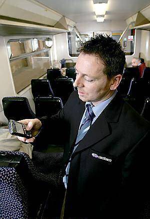 Conductor Steven Lewis using his new Blackberry handset in York 