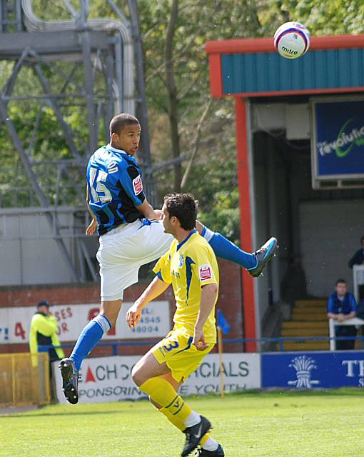 Joe Thompson wins a header above John Nutter.