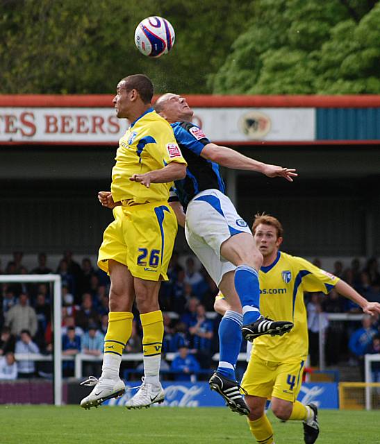 Gary Jones rises with Curtis Weston.