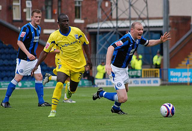 Gary Jones stumbles under a challenge from Albert Jarrett.