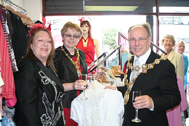 Dressed for success: Mayor of Rochdale, councillor Keith Swift, with Mayoress Sue Etchels, and Frock Exchange owner Linda Howarth