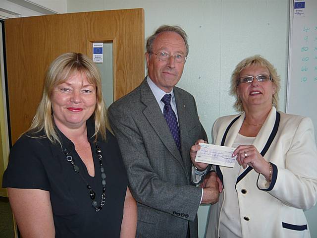 Martin Coupe presents his cheque to Kathy Thomas (left) and Vivien Carter from Rochdale Connections Trust.