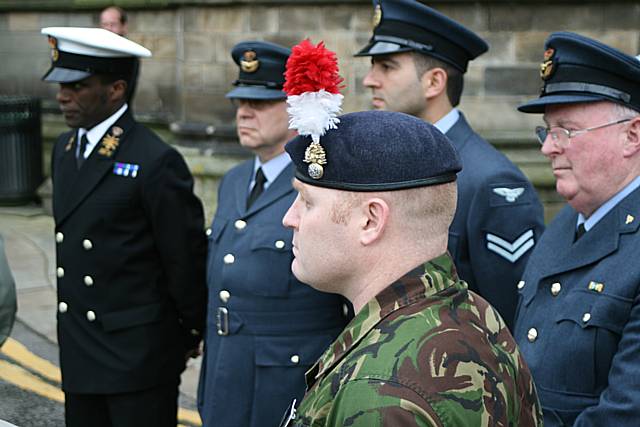 Servicemen gather at the town hall ahead of the flag raising.