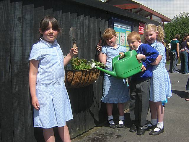 Smithy Bridge school children get their local train station ready for summer.