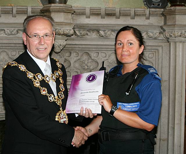 Rochdale town centre ambassadors take their award from the Mayor of Rochdale, Councillor Keith Swift