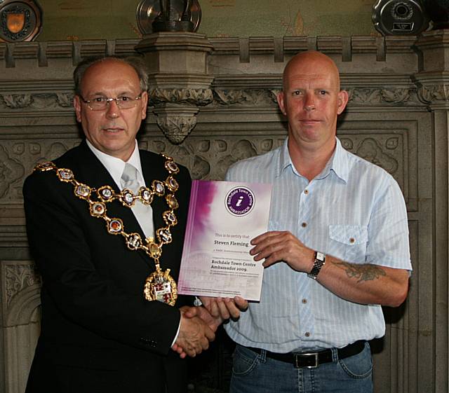 Rochdale town centre ambassadors take their award from the Mayor of Rochdale, Councillor Keith Swift