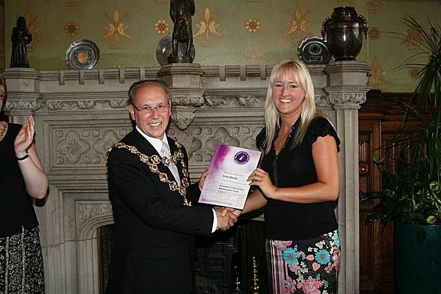 Rochdale town centre ambassadors take their award from the Mayor of Rochdale, Councillor Keith Swift