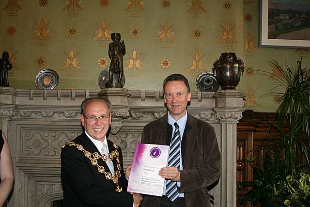 Rochdale town centre ambassadors take their award from the Mayor of Rochdale, Councillor Keith Swift