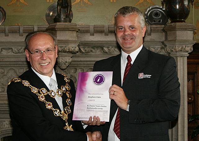 Rochdale town centre ambassadors take their award from the Mayor of Rochdale, Councillor Keith Swift