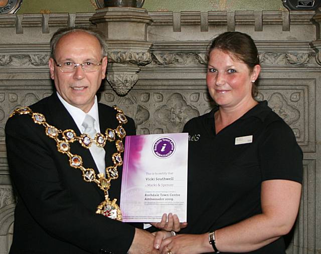 Rochdale town centre ambassadors take their award from the Mayor of Rochdale, Councillor Keith Swift