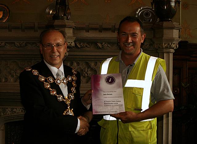 Rochdale town centre ambassadors take their award from the Mayor of Rochdale, Councillor Keith Swift