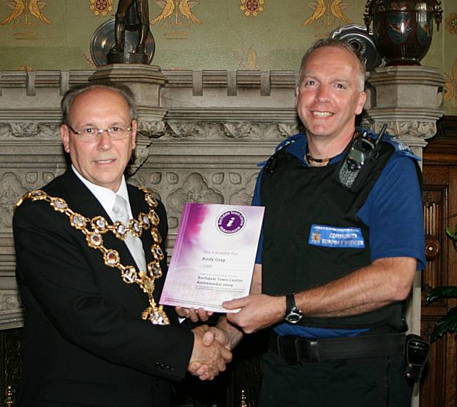 Rochdale town centre ambassadors take their award from the Mayor of Rochdale, Councillor Keith Swift