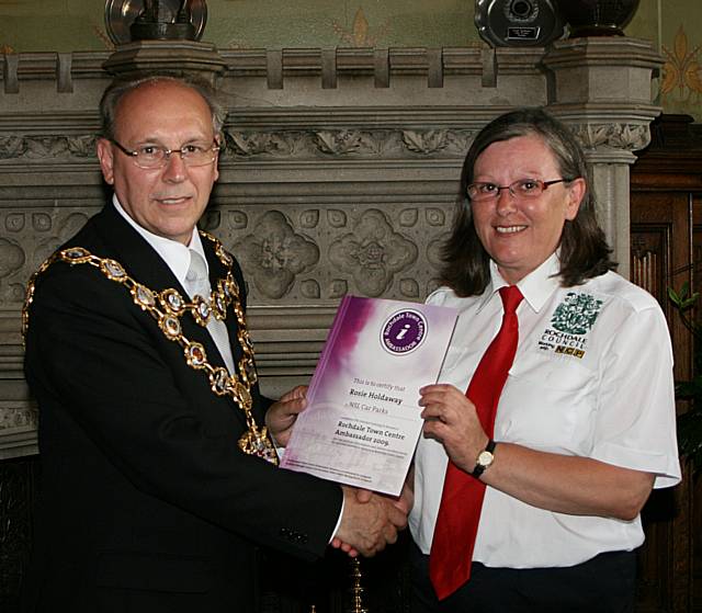 Rochdale town centre ambassadors take their award from the Mayor of Rochdale, Councillor Keith Swift