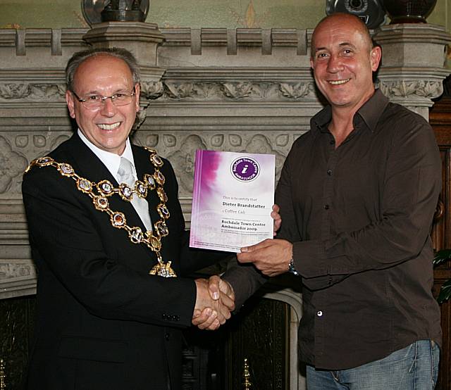 Rochdale town centre ambassadors take their award from the Mayor of Rochdale, Councillor Keith Swift