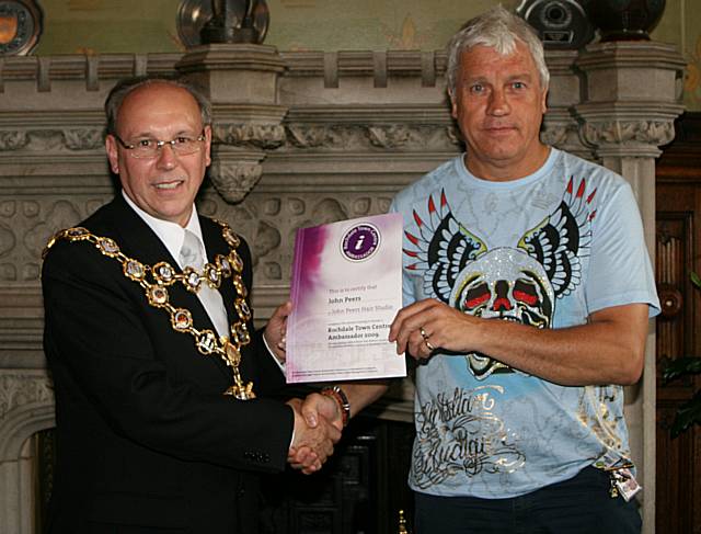 Rochdale town centre ambassadors take their award from the Mayor of Rochdale, Councillor Keith Swift