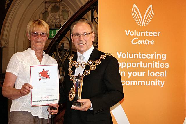 Mal McCall receives her award from Rochdale Mayor Councillor Keith Swift.