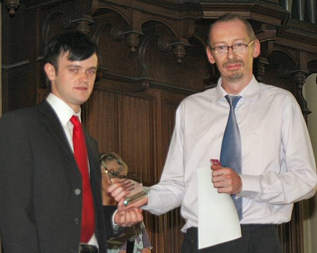 Andrew Anstess from the Backdoor Music Project (Most Committed Young Volunteer of the Year) receives his award from John Swallow, Youth Volunteer Programme Manager.