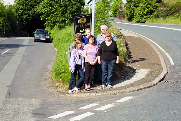 Residents at the junction of Huddersfield Road and Ogden Lane, Newhey 