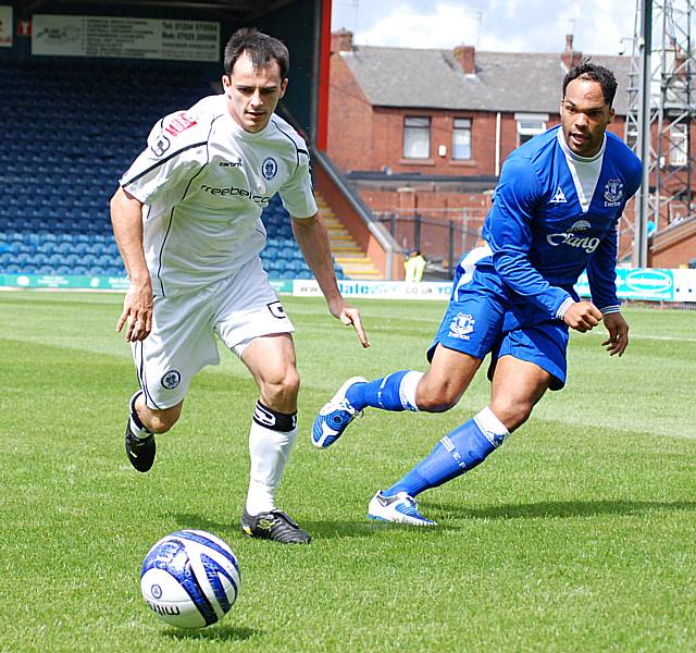 Chris Dagnall holds the ball against Joleon Lescott.