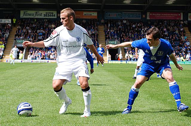 Kallum Higginbotham turns away from Baines.