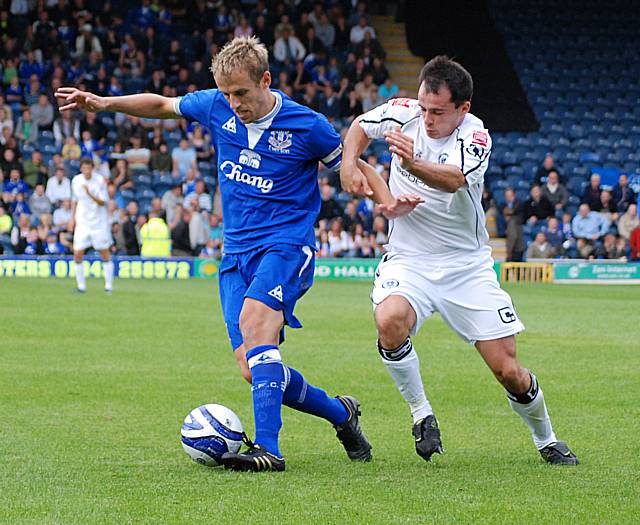 Phil Neville holds off Dagnall.