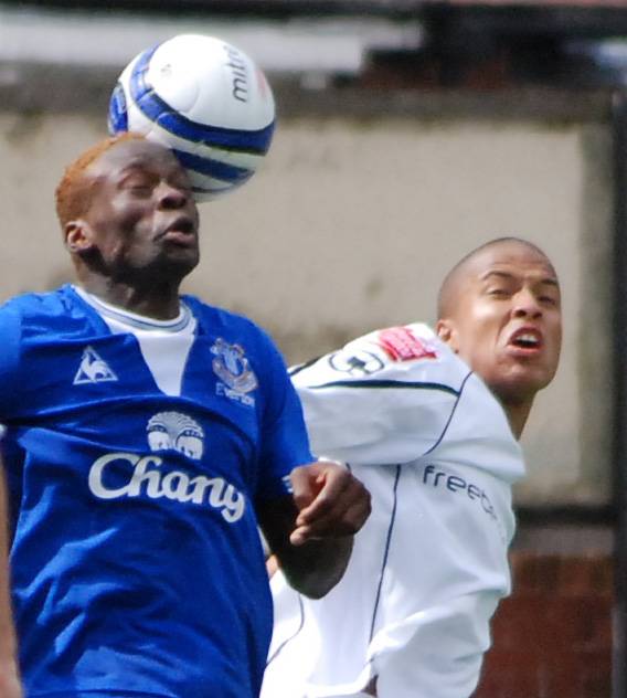 Louis Saha wins a header against Thompson.